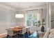 Dining room with pendant lighting, large window, and hardwood floors at 1025 Riverland Woods Pl # 106, Charleston, SC 29412