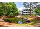 Exterior view of the building with a pond and lush greenery in a serene community at 1025 Riverland Woods Pl # 106, Charleston, SC 29412