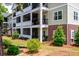 Close up exterior view features balconies with brick accents, greenery, and fresh landscaping at 1025 Riverland Woods Pl # 106, Charleston, SC 29412