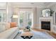 The living room includes a fireplace, hardwood floors, balcony access and seating area at 1025 Riverland Woods Pl # 106, Charleston, SC 29412