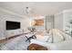 Bright living room with seating, ceiling fan, open floorplan and entertainment center at 1025 Riverland Woods Pl # 106, Charleston, SC 29412