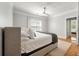 Comfortable main bedroom featuring a large window, soft lighting, and hardwood floors at 1025 Riverland Woods Pl # 106, Charleston, SC 29412