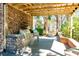 Stone outdoor kitchen featuring stainless steel grill and mini-fridge with a wood pergola and brick seating at 1025 Riverland Woods Pl # 106, Charleston, SC 29412