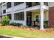 Ground floor patio with black metal railing, green plants, and outdoor seating area at 1025 Riverland Woods Pl # 106, Charleston, SC 29412
