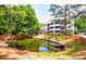 Apartment buildings overlooking a scenic pond surrounded by mature trees and landscaping at 1025 Riverland Woods Pl # 106, Charleston, SC 29412