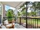 Charming front porch with comfortable seating and view of the surrounding neighborhood at 1025 Riverland Woods Pl # 106, Charleston, SC 29412