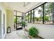 Inviting screened porch with comfortable seating and view of lush landscaping at 1025 Riverland Woods Pl # 106, Charleston, SC 29412