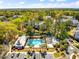 Beautiful community pool surrounded by palm trees and lush greenery on a sunny day at 1025 Riverland Woods Pl # 106, Charleston, SC 29412