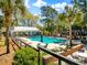 Inviting community pool area with lounge chairs and tables for relaxation and enjoyment at 1025 Riverland Woods Pl # 106, Charleston, SC 29412