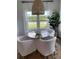 Cozy dining area with round table, four white chairs, natural light, and a decorative wicker light fixture at 1032 Scotch Bonnet Way, Summerville, SC 29485