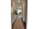 Inviting hallway with dark wood floors and a view into the living room with lots of natural light at 1032 Scotch Bonnet Way, Summerville, SC 29485