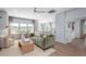 Bright living room with hardwood floors and connected kitchen featuring stainless steel appliances at 1032 Scotch Bonnet Way, Summerville, SC 29485