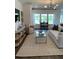 Bright and airy living room with stylish furniture, large windows, and a scenic view at 1032 Scotch Bonnet Way, Summerville, SC 29485