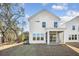 Exterior view of a white house with a screened porch and a spacious backyard at 104 Hawthorne Landing Dr, Goose Creek, SC 29445