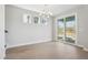 Bright dining room featuring hardwood flooring, a decorative chandelier, and access to the porch at 104 Hawthorne Landing Dr, Goose Creek, SC 29445