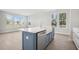 A kitchen island features an undermount sink and stainless steel dishwasher in this open-concept kitchen at 104 Hawthorne Landing Dr, Goose Creek, SC 29445