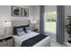 Comfortable bedroom with a cushioned headboard, neutral decor, and a large window providing natural light at 105 Moscato Ln, Summerville, SC 29485