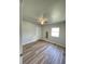This bedroom features wood-look flooring, a ceiling fan, and a window for natural light at 1070 French Quarter Creek Rd, Huger, SC 29450