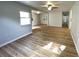A bright, open living space with ceiling fan, wood flooring, and lots of natural light at 1070 French Quarter Creek Rd, Huger, SC 29450