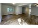 This open living room has new wood floors, fresh paint, and bright natural light at 1070 French Quarter Creek Rd, Huger, SC 29450