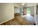 An open-concept living room with wood floors, access to the backyard, and lots of natural light at 1070 French Quarter Creek Rd, Huger, SC 29450