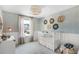 This Bedroom features an accent wall with unique decor, modern light fixture and a crib at 109 Moscato Ln, Summerville, SC 29485