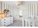 This Bedroom features a cozy design with a unique chandelier and striped wallpaper, creating a comforting atmosphere at 108 Moscato Ln, Summerville, SC 29485