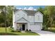 Charming two-story home with light-blue siding, a cozy porch, and an attached two-car garage at 109 Moscato Ln, Summerville, SC 29485
