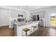 Well-lit kitchen boasts stainless appliances, gray cabinetry, and a granite island with seating at 109 Moscato Ln, Summerville, SC 29485