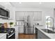 Kitchen showcases stainless appliances, granite countertops, and hardwood floors at 109 Moscato Ln, Summerville, SC 29485