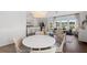 Open-concept living room and dining area featuring wood floors, a modern chandelier, and backyard views at 109 Moscato Ln, Summerville, SC 29485