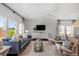Bright living room featuring modern decor, large windows, and hardwood floors at 109 Moscato Ln, Summerville, SC 29485
