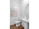 Stylish powder room with shiplap accent wall, round mirror, and a pedestal sink at 109 Moscato Ln, Summerville, SC 29485