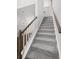 Carpeted staircase with white railing and wood banister leads to the upper level at 109 Moscato Ln, Summerville, SC 29485