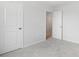 A bright bedroom with neutral carpet, white walls, and a view into an adjacent room at 110 Moscato Ln, Summerville, SC 29485