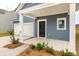 Inviting front porch with white columns leading to the entrance and an attached two-car garage at 111 Moscato Ln, Summerville, SC 29485