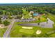 Aerial view of community with golf course, lake, clubhouse, and pool at 114 Shadowmoss Pkwy, Charleston, SC 29414