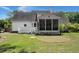 Home's backyard features a deck, a screened porch, and a well maintained lawn at 114 Shadowmoss Pkwy, Charleston, SC 29414