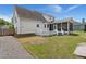 View of the home's back exterior, including a deck and screened in porch at 114 Shadowmoss Pkwy, Charleston, SC 29414