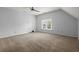 Bright bedroom features neutral carpet, ceiling fan, and large window with natural light at 114 Shadowmoss Pkwy, Charleston, SC 29414