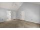 Spacious bedroom featuring a ceiling fan, carpet floors, and two entry doors at 114 Shadowmoss Pkwy, Charleston, SC 29414