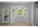 Sun-filled breakfast nook with a bay window, modern light fixture and a view of the backyard at 114 Shadowmoss Pkwy, Charleston, SC 29414