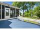Outdoor deck with a bench, screened porch, and serene backyard views at 114 Shadowmoss Pkwy, Charleston, SC 29414