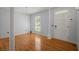 Welcoming foyer with gleaming hardwood floors and a classic column adding architectural detail at 114 Shadowmoss Pkwy, Charleston, SC 29414