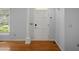 Bright foyer with hardwood floors, fresh paint, and natural light streaming through the window at 114 Shadowmoss Pkwy, Charleston, SC 29414
