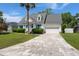 A traditional home with a concrete driveway leading to a two-car garage with a well-manicured lawn at 114 Shadowmoss Pkwy, Charleston, SC 29414