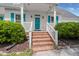 Inviting front porch with brick steps, white railings, and a vibrant blue front door at 114 Shadowmoss Pkwy, Charleston, SC 29414