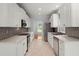 Modern kitchen with white cabinets, stainless steel appliances, and elegant backsplash at 114 Shadowmoss Pkwy, Charleston, SC 29414