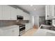 Contemporary kitchen with white cabinets, stainless steel appliances, and quartz countertops at 114 Shadowmoss Pkwy, Charleston, SC 29414