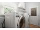 Functional laundry room featuring a washer and dryer with access to the outdoors at 114 Shadowmoss Pkwy, Charleston, SC 29414